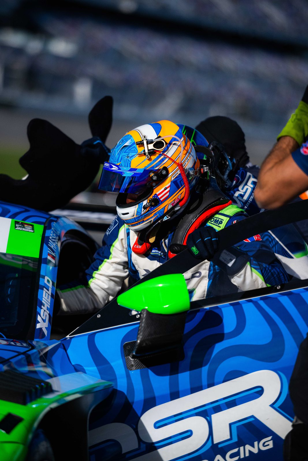 Rory van der Steur in his helmet climbing into the #19 Vantage GT3 at Daytona